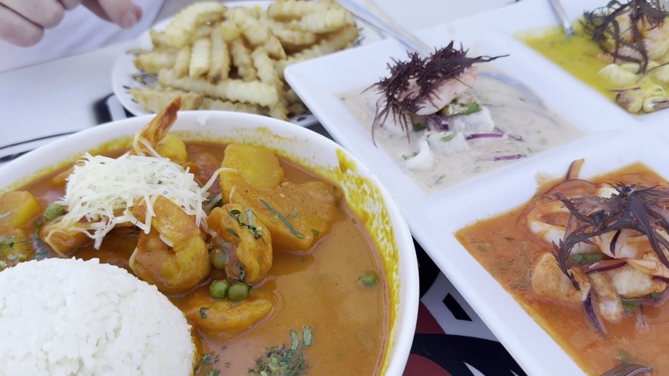 Plated seafood beside beachside dining